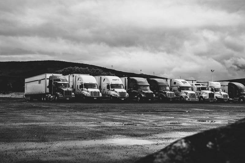 Fleet of HGV trucks parked at a transport depot
